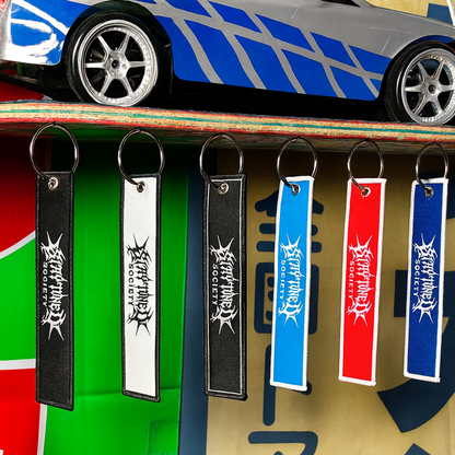 StayTuned Woven Jet Tag Keychain – Premium Woven Logo + Embroidered Edge
